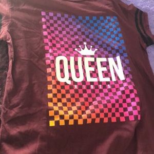 Shirt says “Queen vibes”